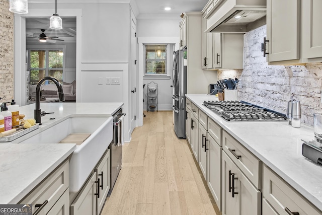 265 Federal St, Athens, GA 30607 - kitchen featuring appliances with stainless steel finishes, custom range hood, ceiling fan, decorative backsplash, and light wood-style floors
