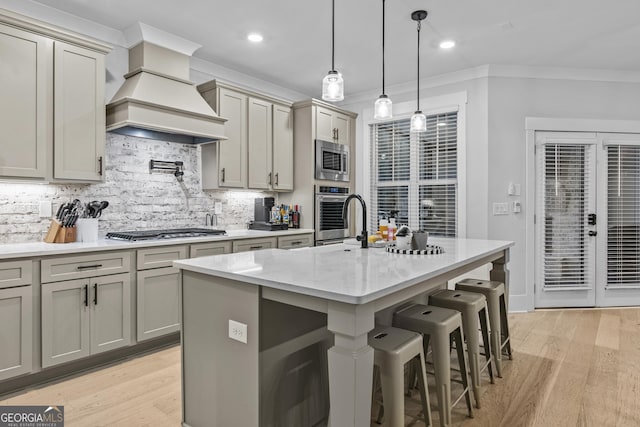 265 Federal St, Athens, GA 30607 - kitchen featuring appliances with stainless steel finishes, crown molding, tasteful backsplash, gray cabinetry, and light stone countertops