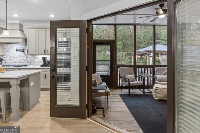 265 Federal St, Athens, GA 30607 - kitchen featuring a ceiling fan, light wood-style flooring, tasteful backsplash, recessed lighting, and custom range hood