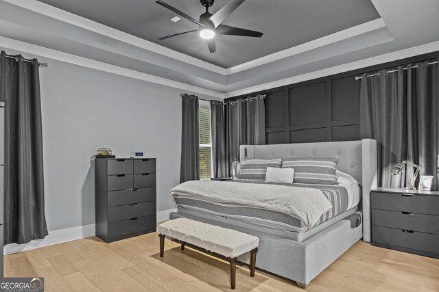 265 Federal St, Athens, GA 30607 - bedroom with a tray ceiling, light wood-type flooring, and a ceiling fan