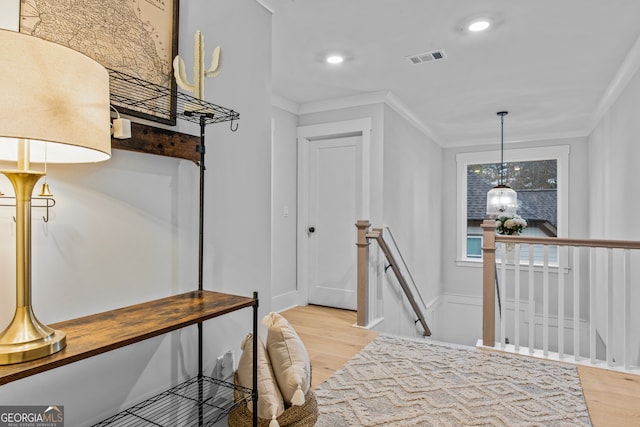 interior space with ornamental molding and light wood-type flooring