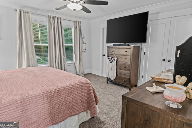 bedroom featuring ceiling fan, light colored carpet, and crown molding