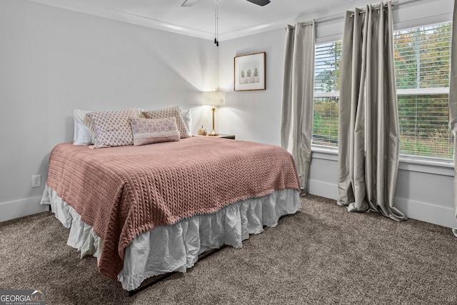 carpeted bedroom featuring ceiling fan and ornamental molding