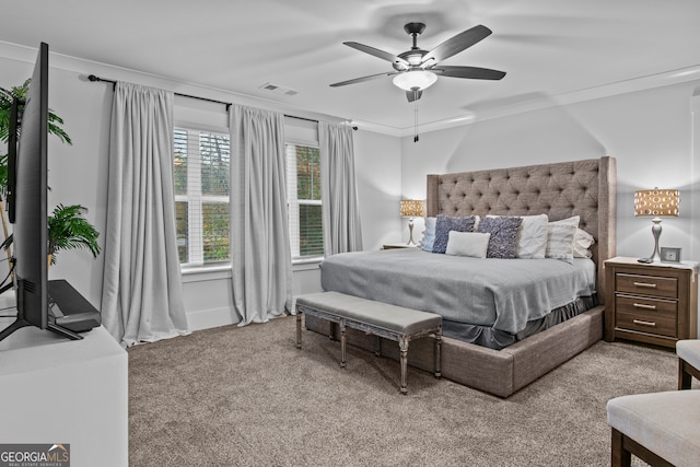 bedroom with light carpet, ceiling fan, and crown molding