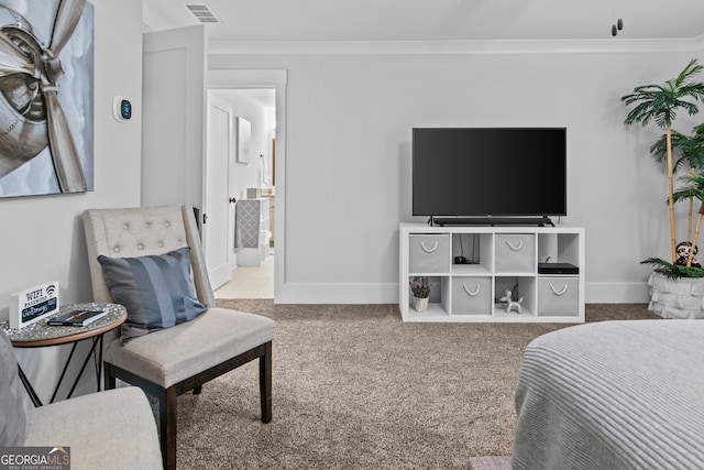 bedroom with carpet flooring, ensuite bathroom, and crown molding