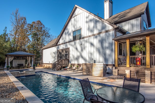 back of property with a gazebo and a patio