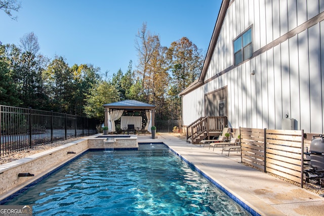 view of swimming pool with a gazebo and an in ground hot tub