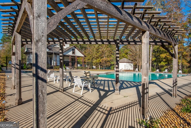 view of swimming pool featuring a pergola and a patio