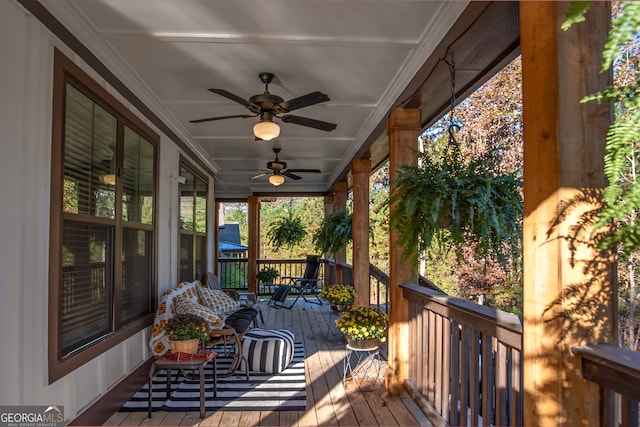 deck featuring covered porch and ceiling fan