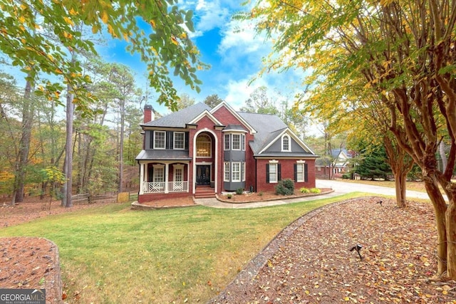 view of front of home with a front yard and a porch