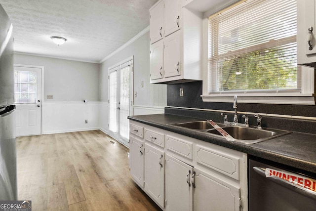 117 Neal Ave, Stockbridge, GA 30281 - kitchen with dishwasher, a sink, ornamental molding, white cabinetry, and dark countertops