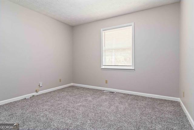 117 Neal Ave, Stockbridge, GA 30281 - unfurnished room featuring carpet, baseboards, and a textured ceiling