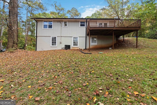 rear view of property featuring a wooden deck, cooling unit, and a lawn