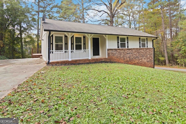 single story home with a front yard and a porch