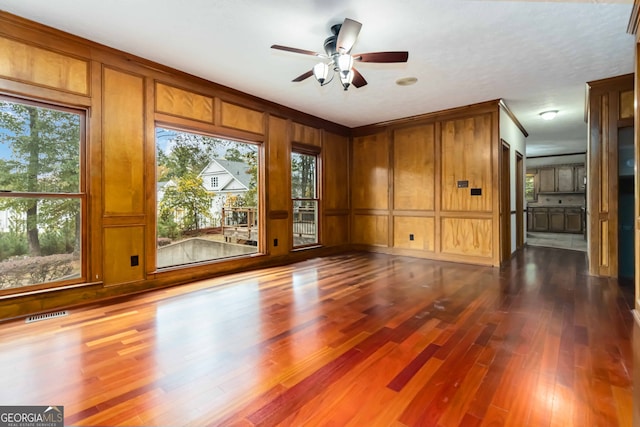 unfurnished living room with hardwood / wood-style flooring and a healthy amount of sunlight