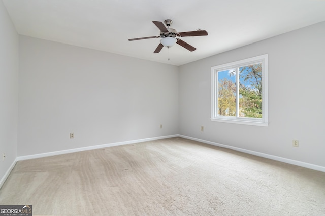 spare room with light carpet and ceiling fan