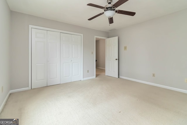 unfurnished bedroom with ceiling fan, a closet, and carpet floors