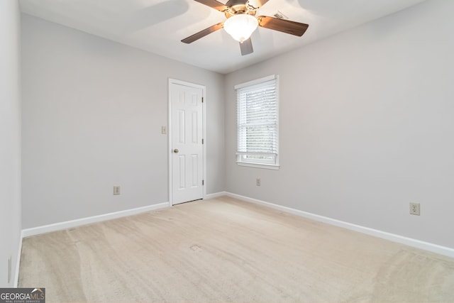 carpeted empty room featuring ceiling fan