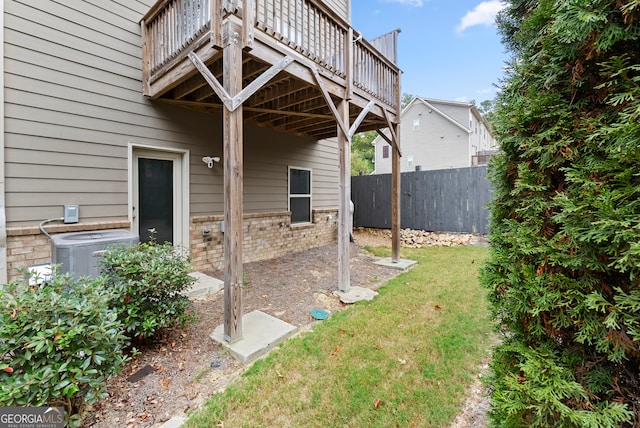 view of yard featuring central AC and a deck