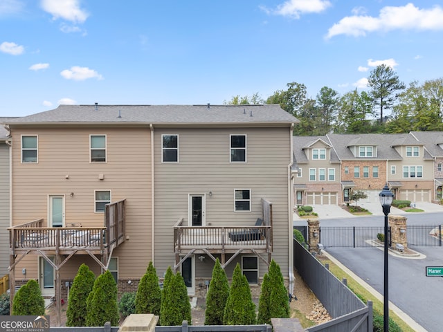 back of house featuring a deck