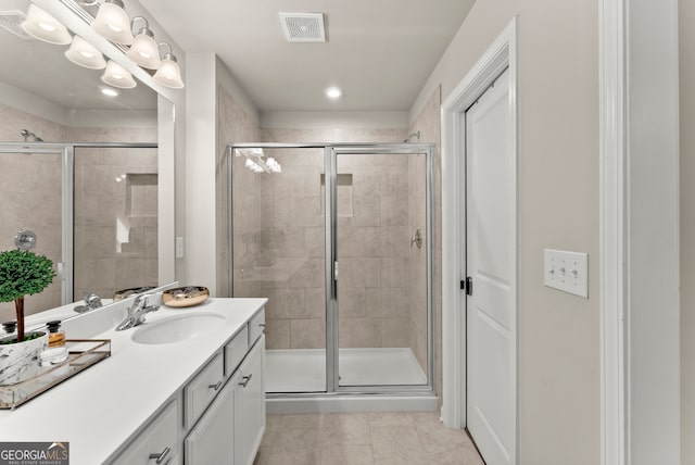 bathroom with vanity, tile patterned floors, and walk in shower