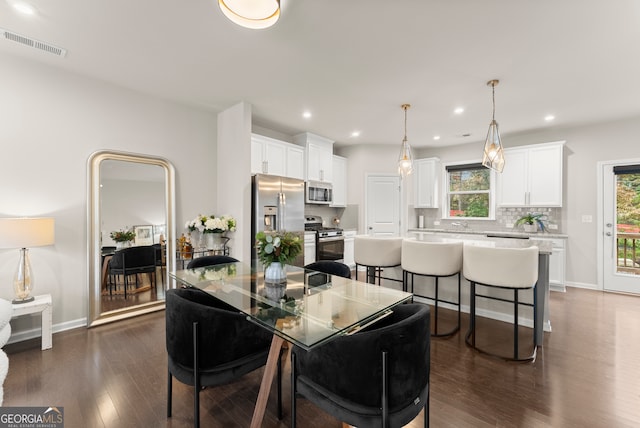 dining room with dark hardwood / wood-style flooring