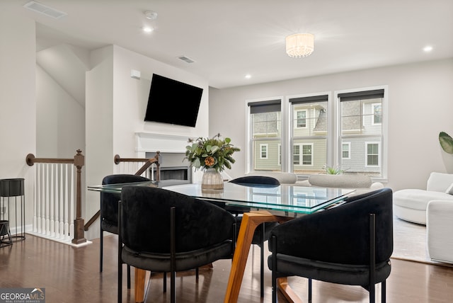 dining space with dark hardwood / wood-style flooring