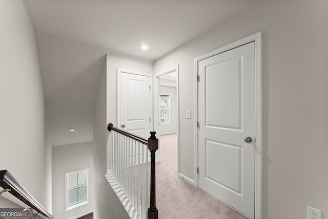 hallway featuring light colored carpet