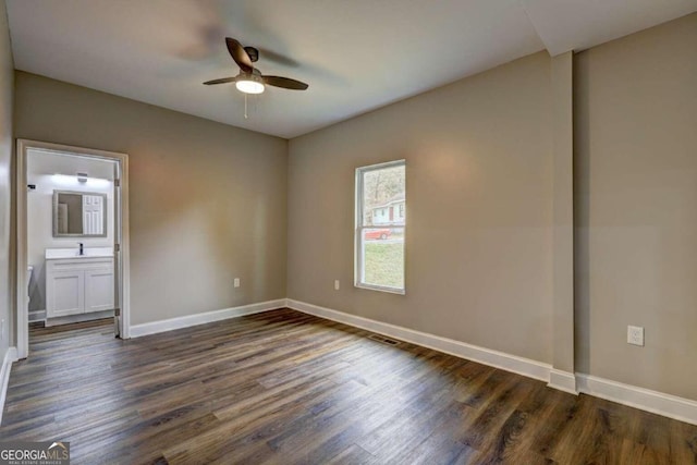 unfurnished room with dark wood-type flooring, ceiling fan, and sink