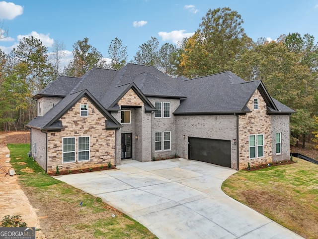 view of front of property featuring a garage and a front lawn