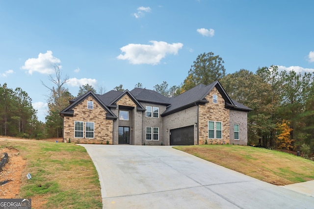 view of front of property with a front lawn and a garage