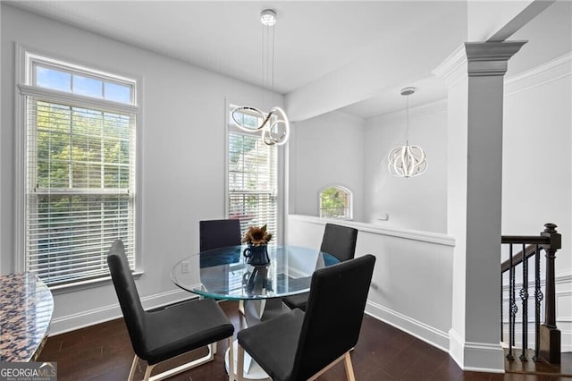 dining area featuring ornate columns, dark wood-type flooring, a healthy amount of sunlight, and a notable chandelier