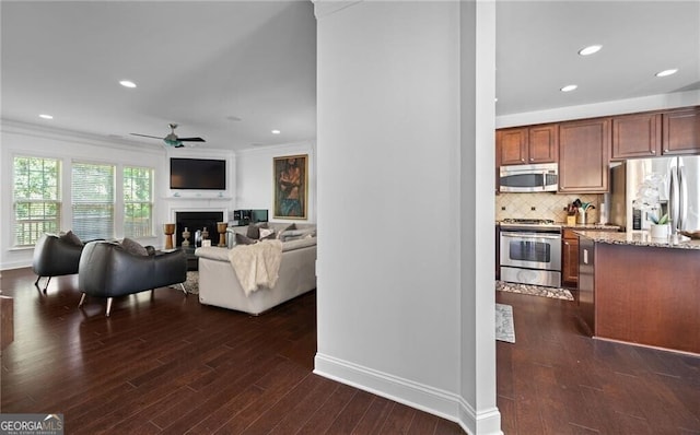 living room featuring crown molding, dark hardwood / wood-style floors, and ceiling fan