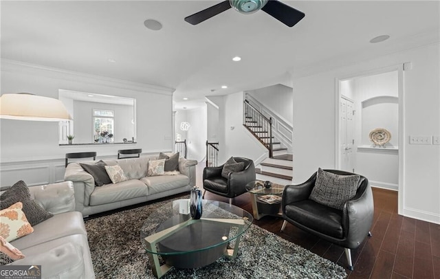 living room with ornamental molding, dark hardwood / wood-style flooring, and ceiling fan