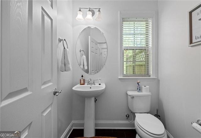 bathroom with tile patterned flooring, sink, and toilet