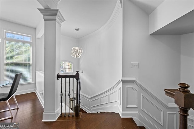 staircase featuring ornate columns, a wealth of natural light, and wood-type flooring