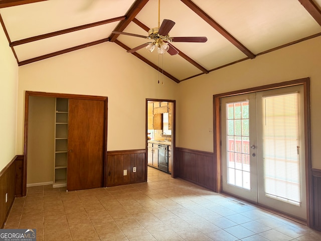 interior space featuring wood walls, sink, ceiling fan, vaulted ceiling with beams, and french doors