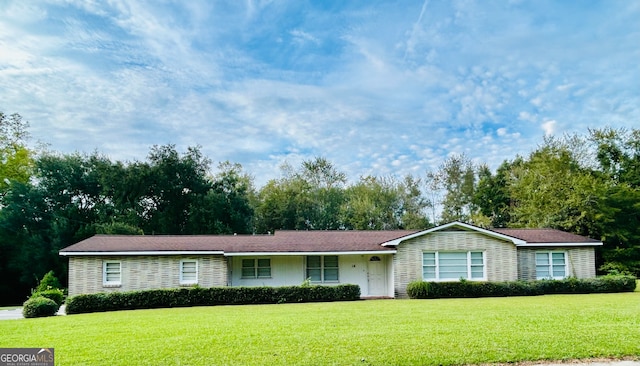 ranch-style home featuring a front yard