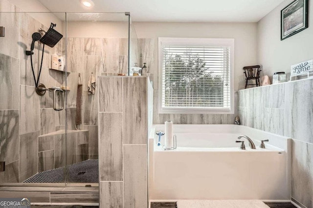 bathroom with shower with separate bathtub