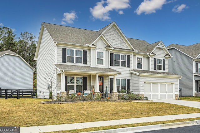 craftsman inspired home featuring a garage and a front lawn