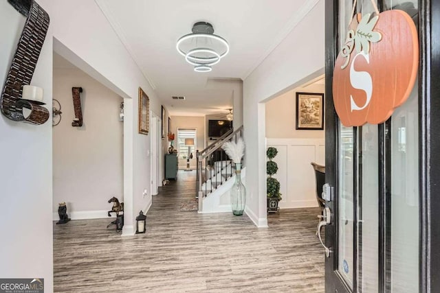 interior space featuring hardwood / wood-style floors and ornamental molding