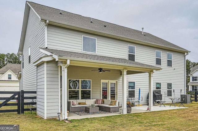 back of property featuring a lawn, ceiling fan, a patio, and an outdoor hangout area