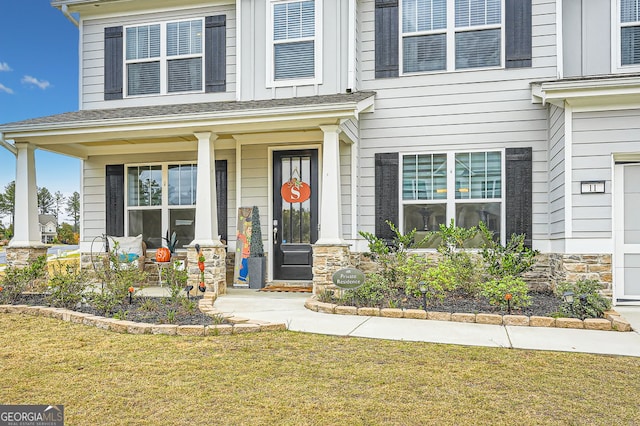 view of front of property with covered porch and a front yard