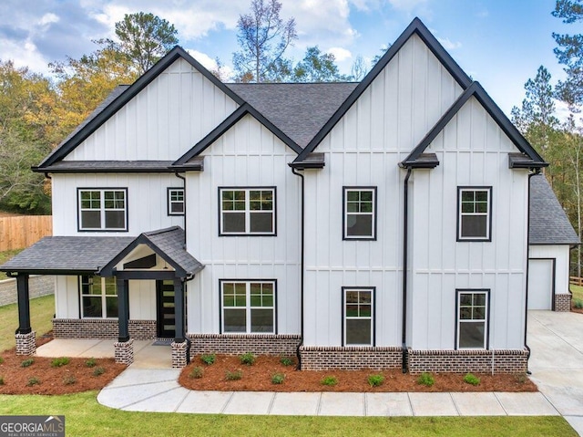 modern inspired farmhouse featuring a garage and a front lawn