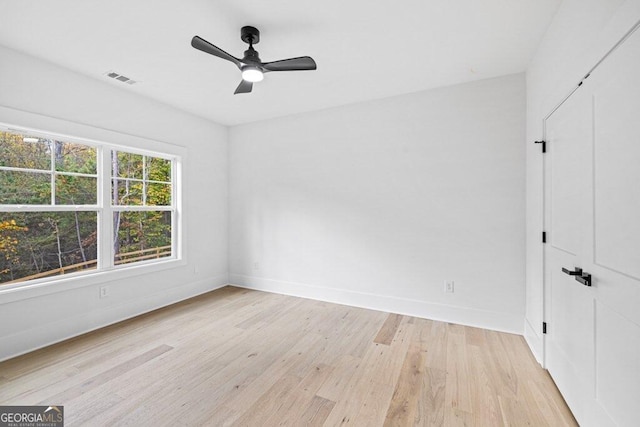 empty room with light wood-type flooring and ceiling fan