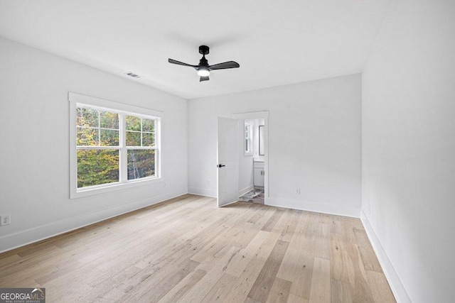 unfurnished bedroom featuring ensuite bath, ceiling fan, and light hardwood / wood-style flooring