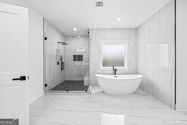 bathroom with shower with separate bathtub