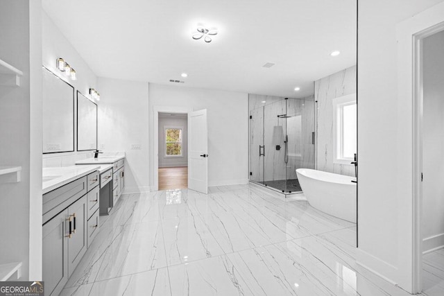 bathroom featuring shower with separate bathtub and vanity