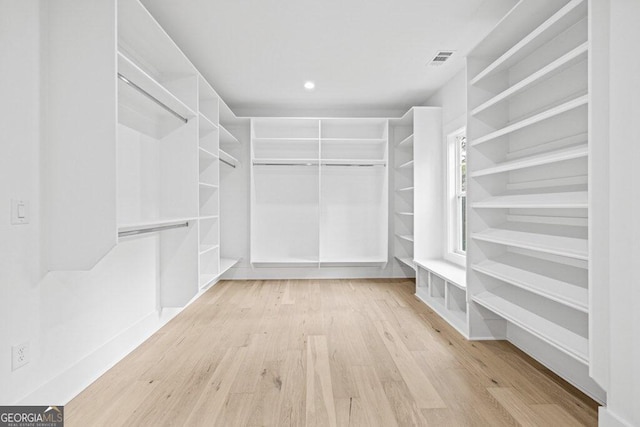 walk in closet featuring light hardwood / wood-style floors