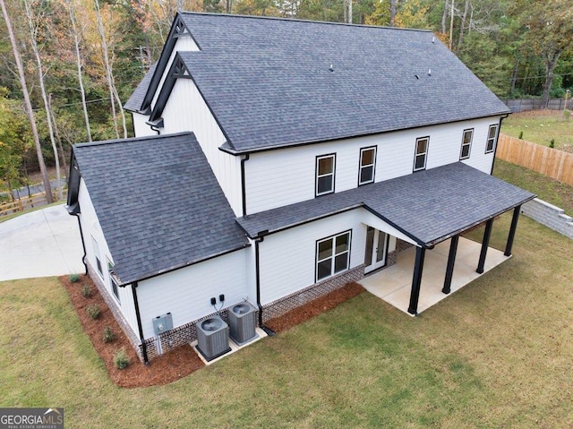 rear view of property featuring a patio area, a lawn, and cooling unit